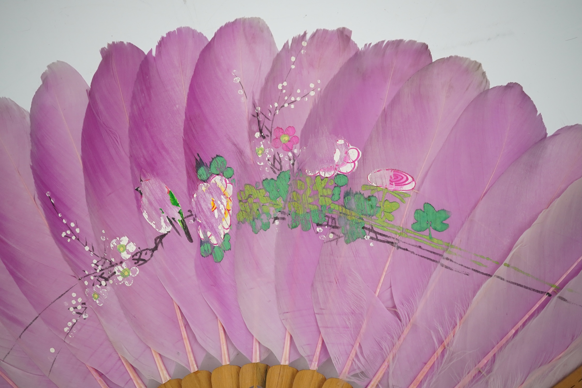 Three 19th century Chinese feather fans: One a carved bone brise black feather fan together with two similar carved sandalwood feather fans, two fans have hand painted decoration on the feathers both sides, the pink feat